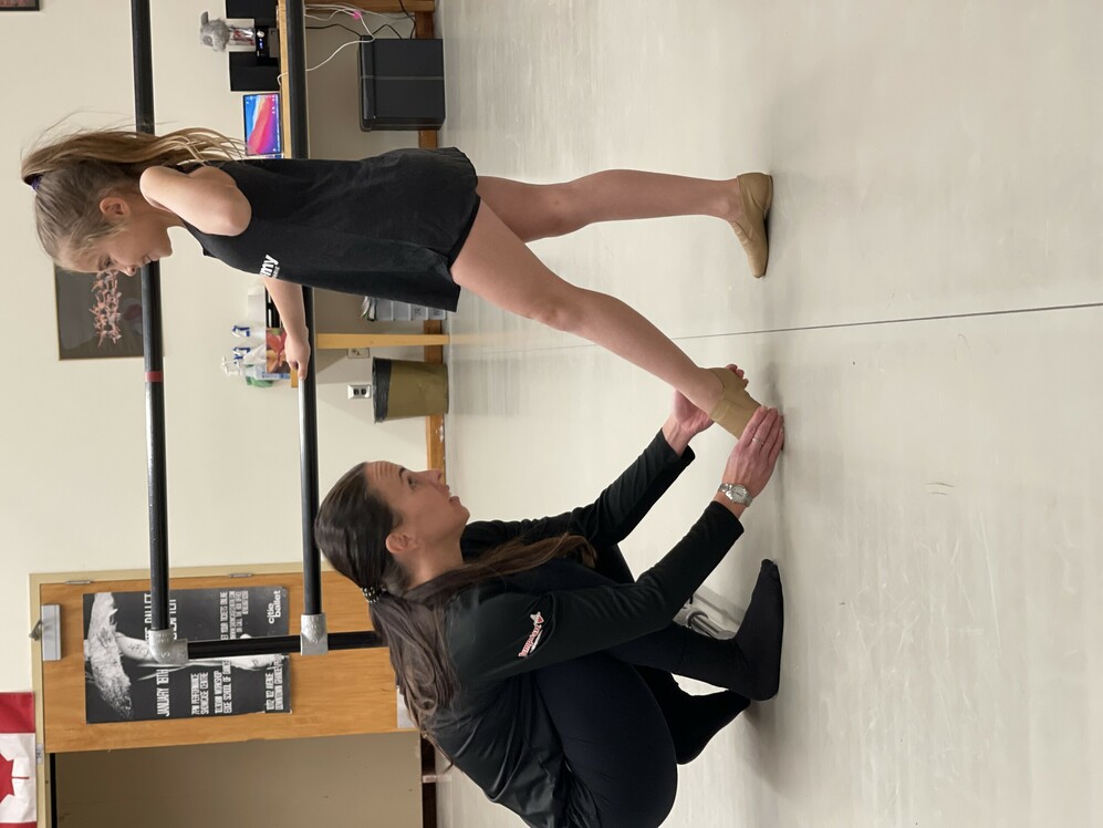 teacher helping student with toe point