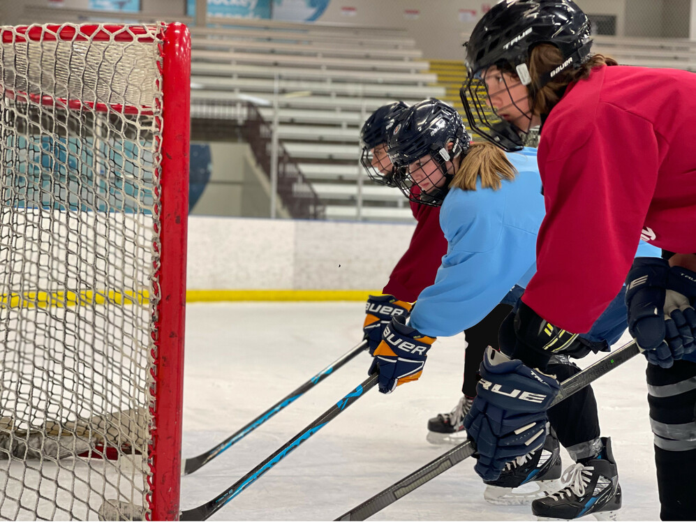 students playing ice hockey