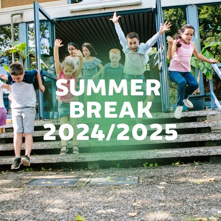 A group of smiling elementary school children excitedly jump down the steps outside a school building, arms raised in joy. The background shows open glass doors and leafy trees. Overlaid text in bold white letters reads: “SUMMER BREAK 2024/2025.” A light