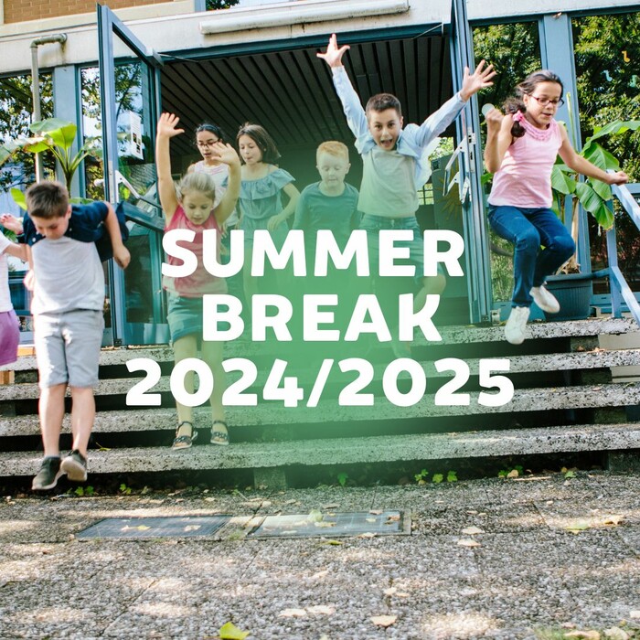 A group of smiling elementary school children excitedly jump down the steps outside a school building, arms raised in joy. The background shows open glass doors and leafy trees. Overlaid text in bold white letters reads: “SUMMER BREAK 2024/2025.” A light